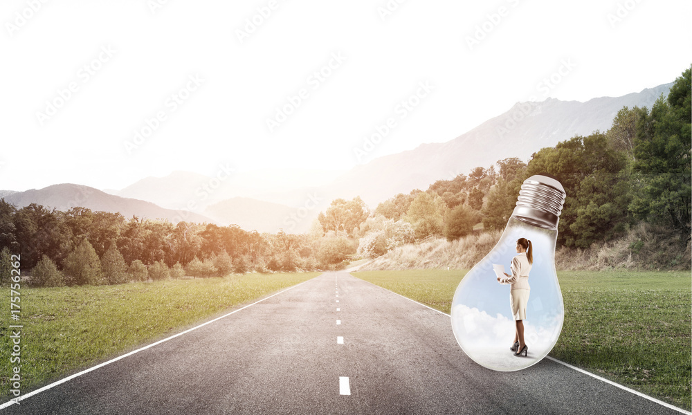 Businesswoman inside light bulb