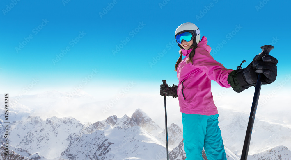 Happy young woman skier enjoying sunny weather in Alps