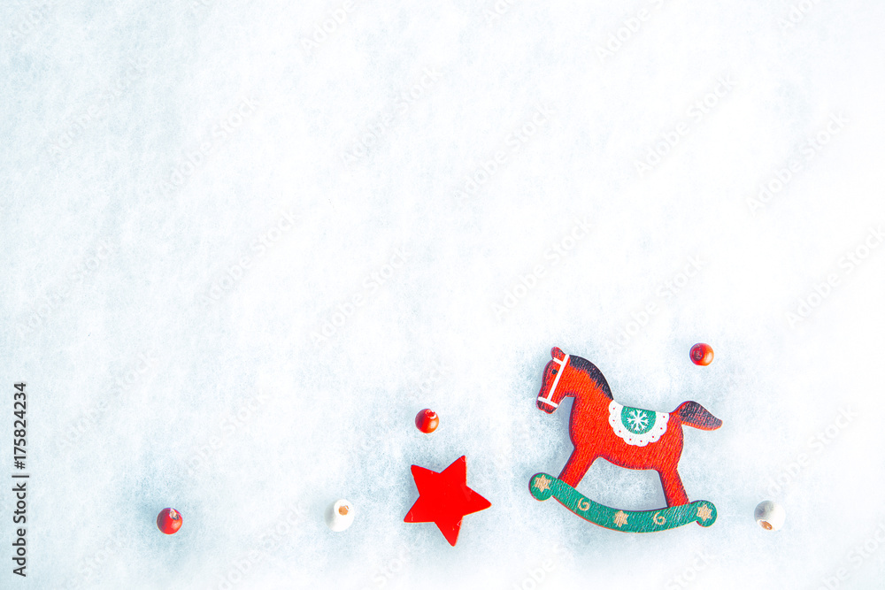 Rocking horse decoration on snow background