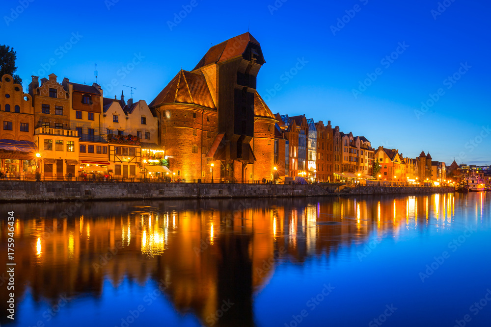 Gdansk at night with historic port crane reflected in Motlawa river, Poland