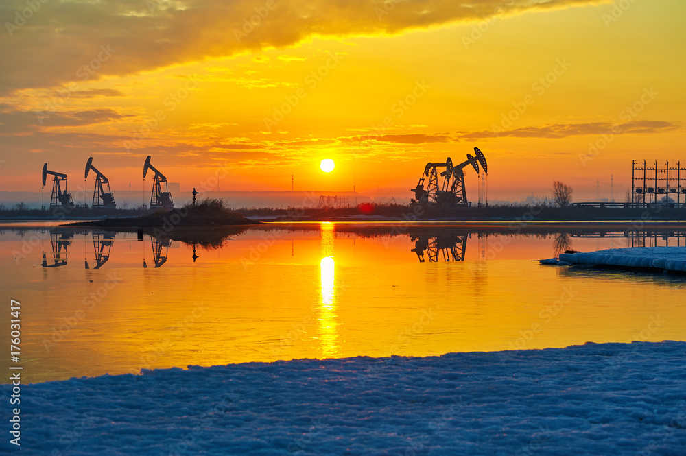 The sunrise of oil field landscape