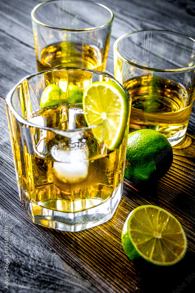 glass of whiskey on dark wooden background