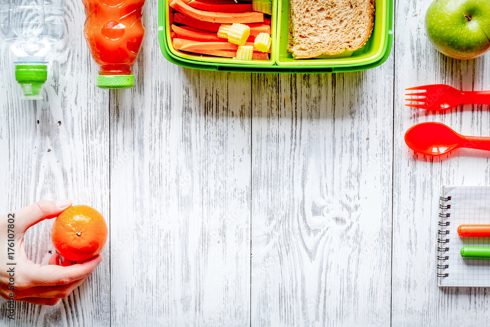 kid menu lunchbox for school top view on wooden background