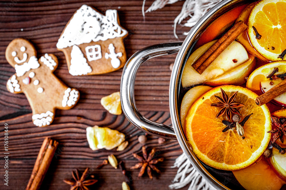 preparation of mulled wine in pot wooden background top view