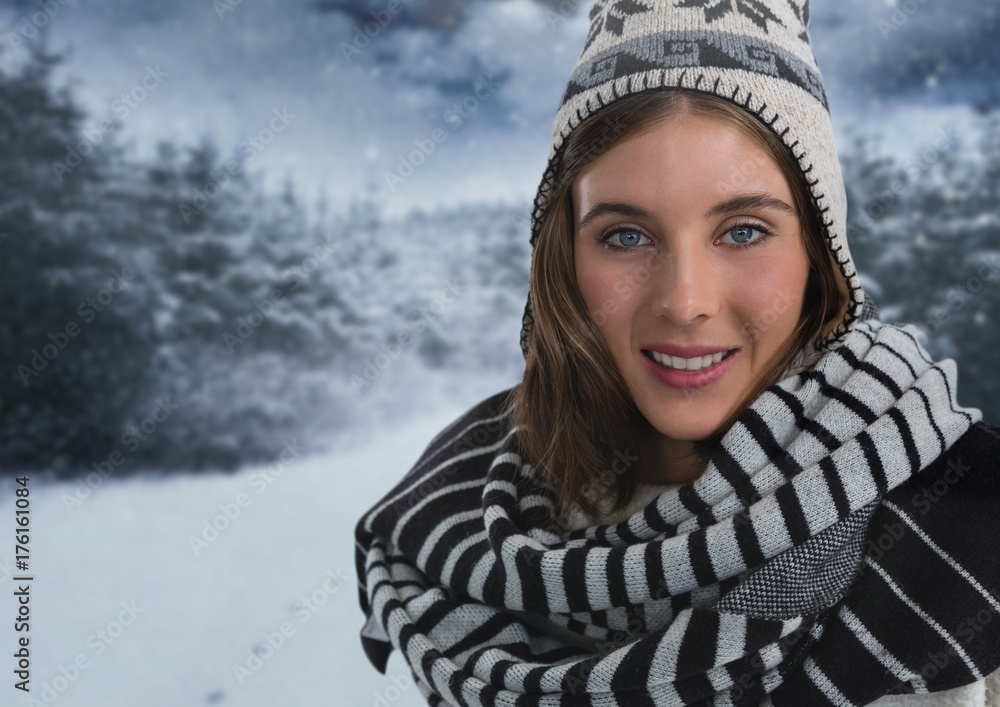 Woman with scarf and hat in snow forest at night