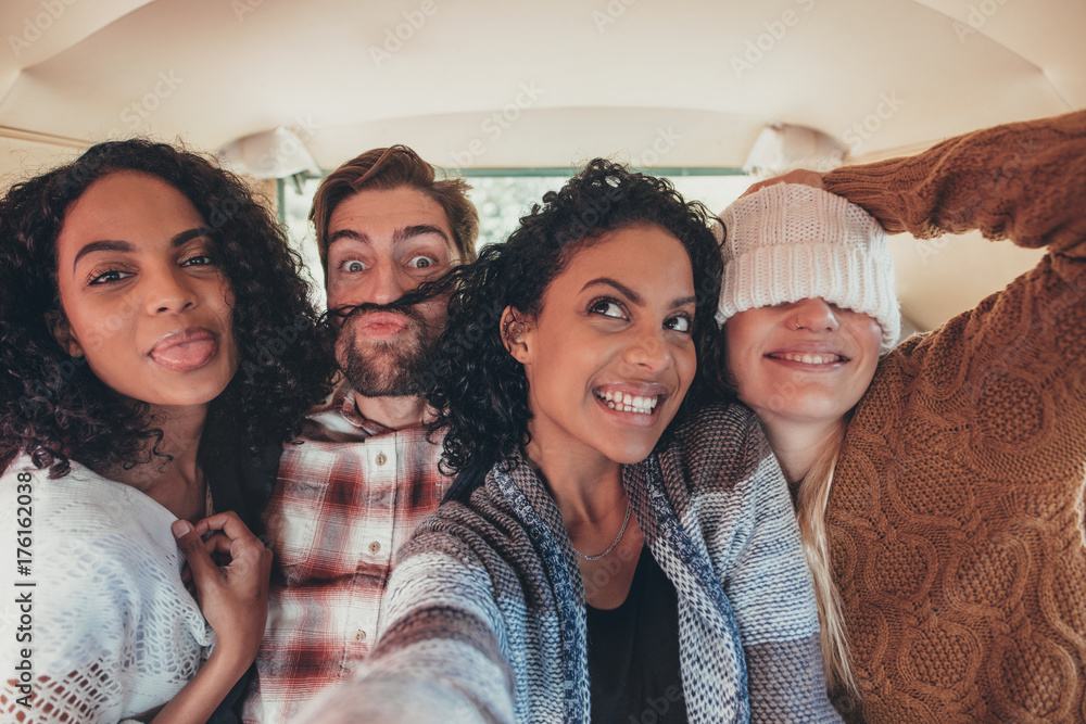 Friends taking selfie on road trip