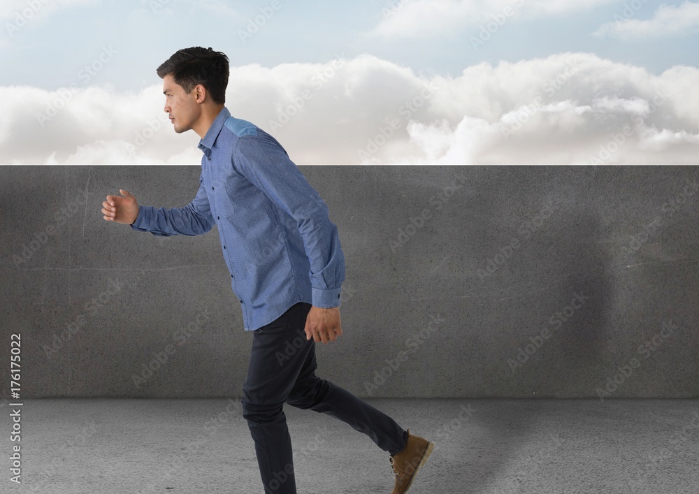 Businessman full body_Businessman running by stone wall and