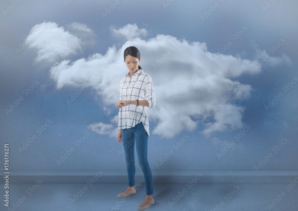 Businesswoman checking the time on watch with clouds