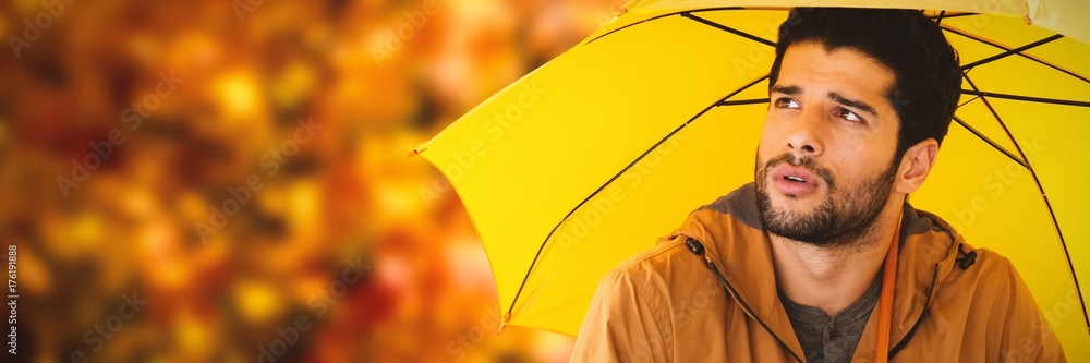 有思想的年轻人撑着黄色雨伞的合成图像