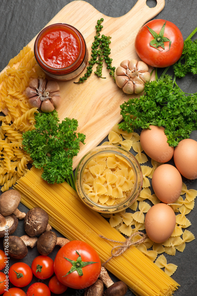 Italian food concept. Pasta ingredients. Cherry-tomatoes, spaghetti pasta, rosemary and spices