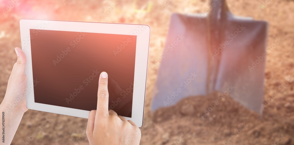 Composite image of woman using tablet pc 