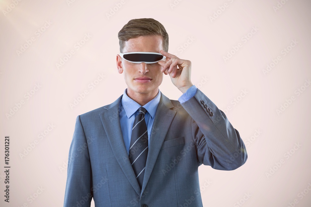 Composite image of handsome businessman virtual reality glasses