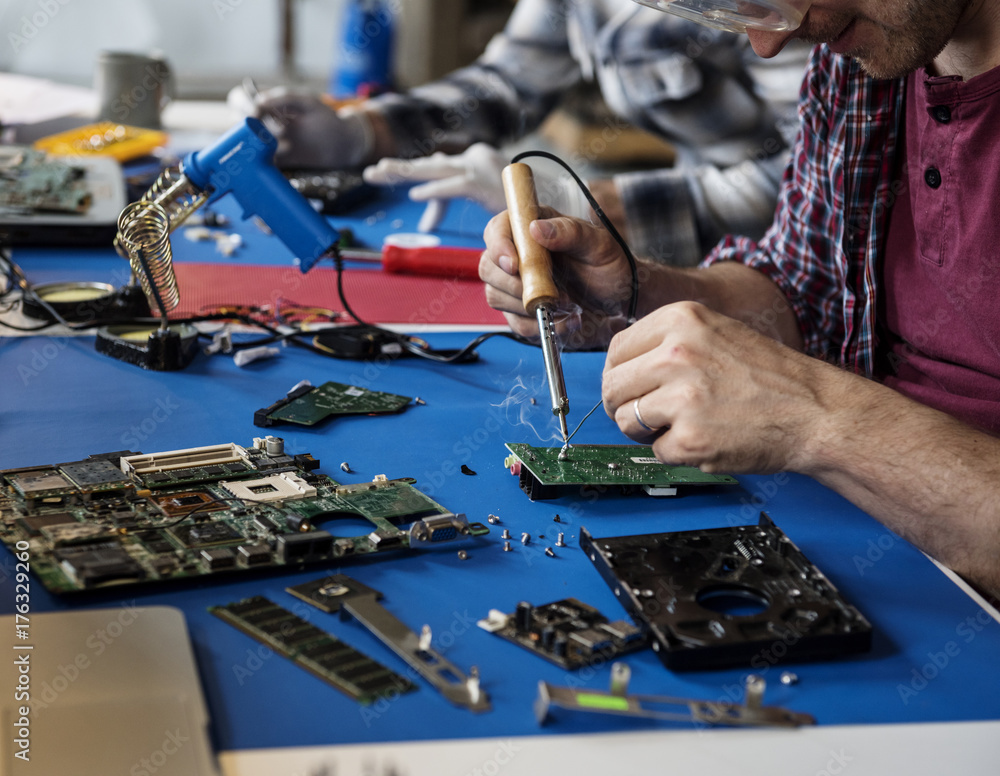 Hand soldering tin on electronics circuit board