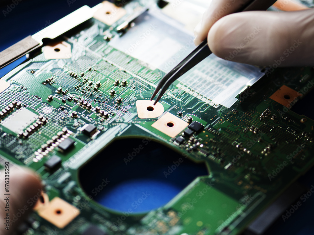 Closeup of hands working on computer motherboard