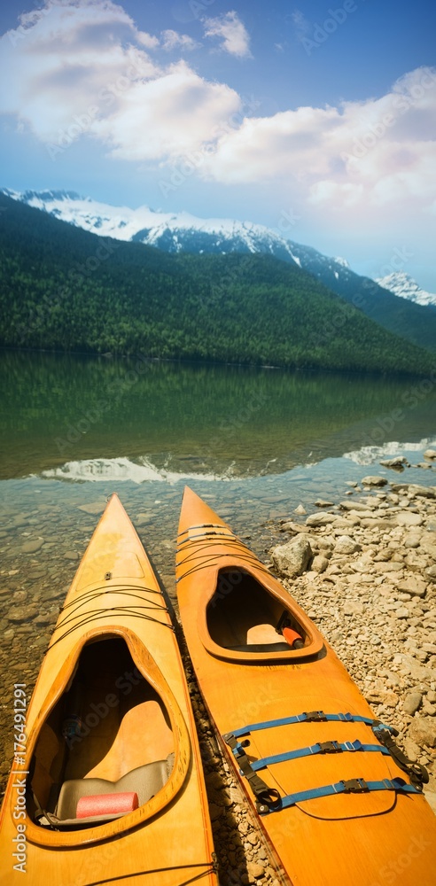 Kayaks at lakeshore on sunny day