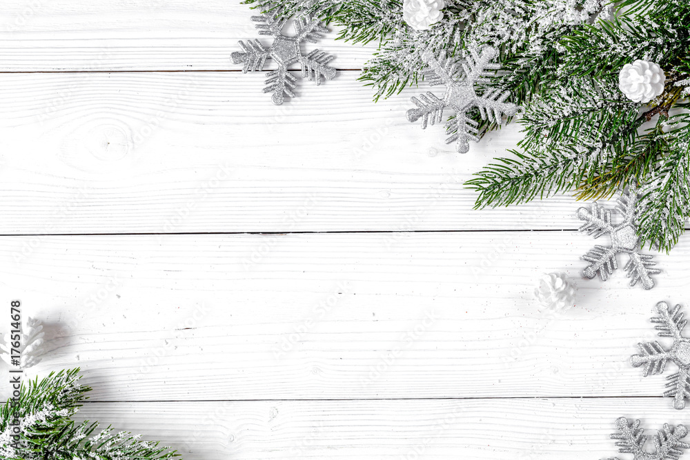 Christmas toys and spruce branches on wooden background top view