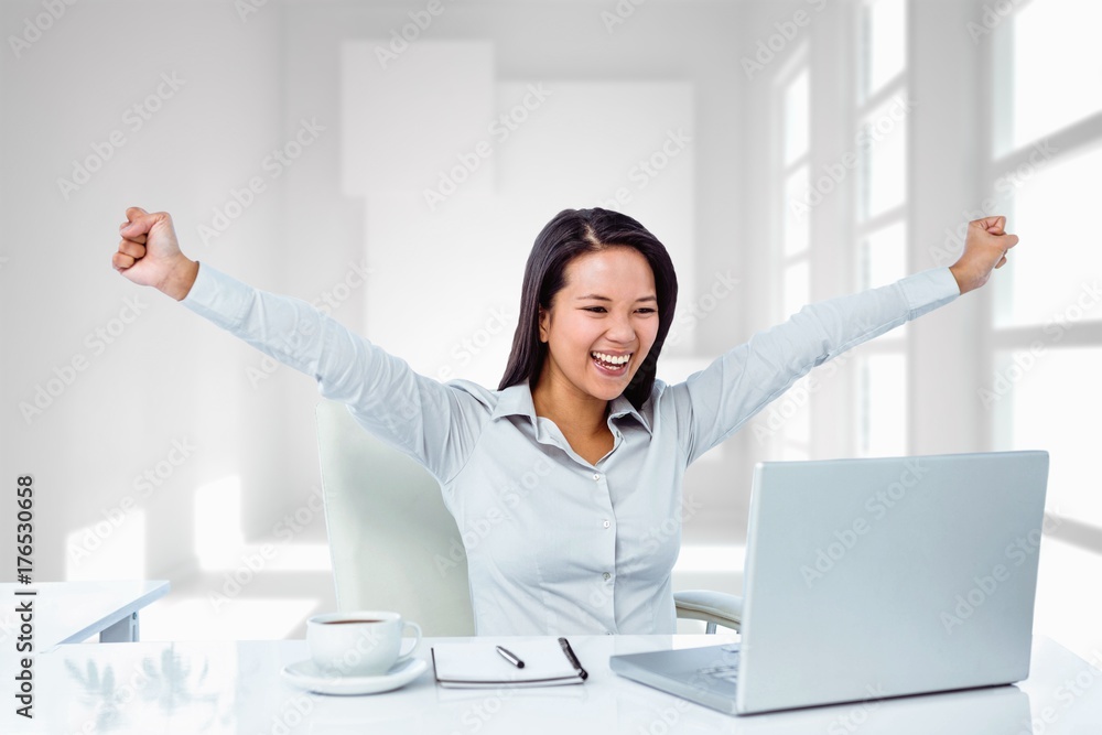 Composite image of happy businesswoman with raised arms