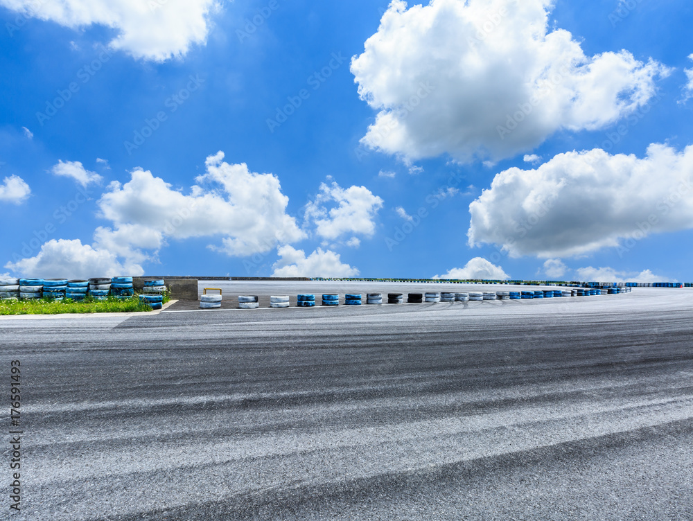 Asphalt road circuit and sky clouds with car tire brake