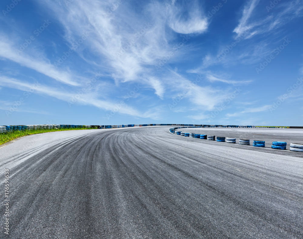 Asphalt road circuit and sky clouds with car tire brake