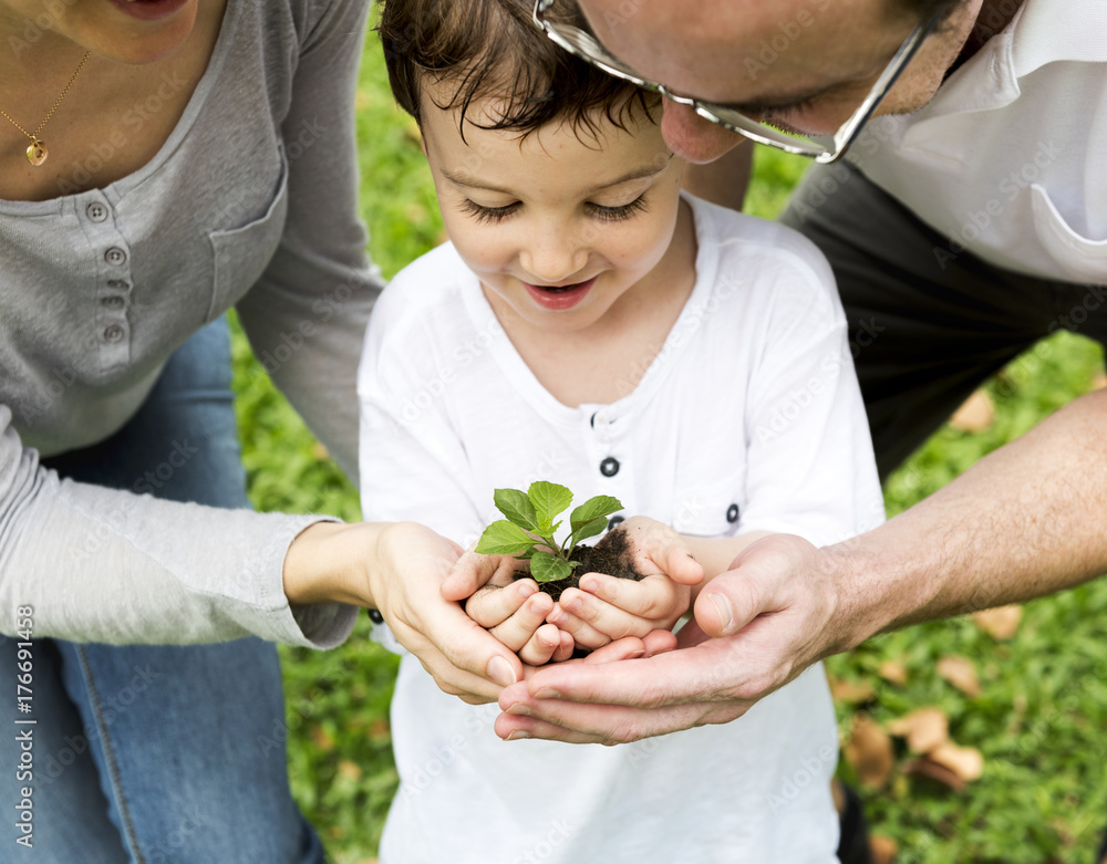 Family planting a tree together