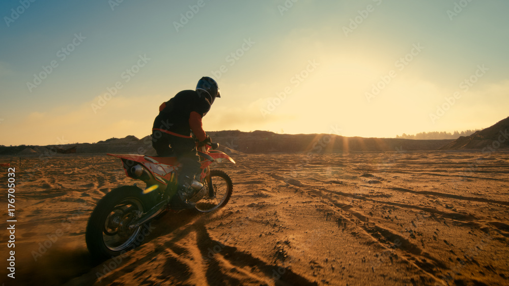 Shot of the Professional Motocross Driver Riding on His FMX Motorcycle on the Extreme Off-Road Terra