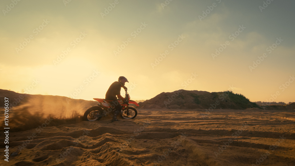 Shot of the Professional Motocross Driver Turning on His FMX Motorcycle on the Extreme Off-Road Terr