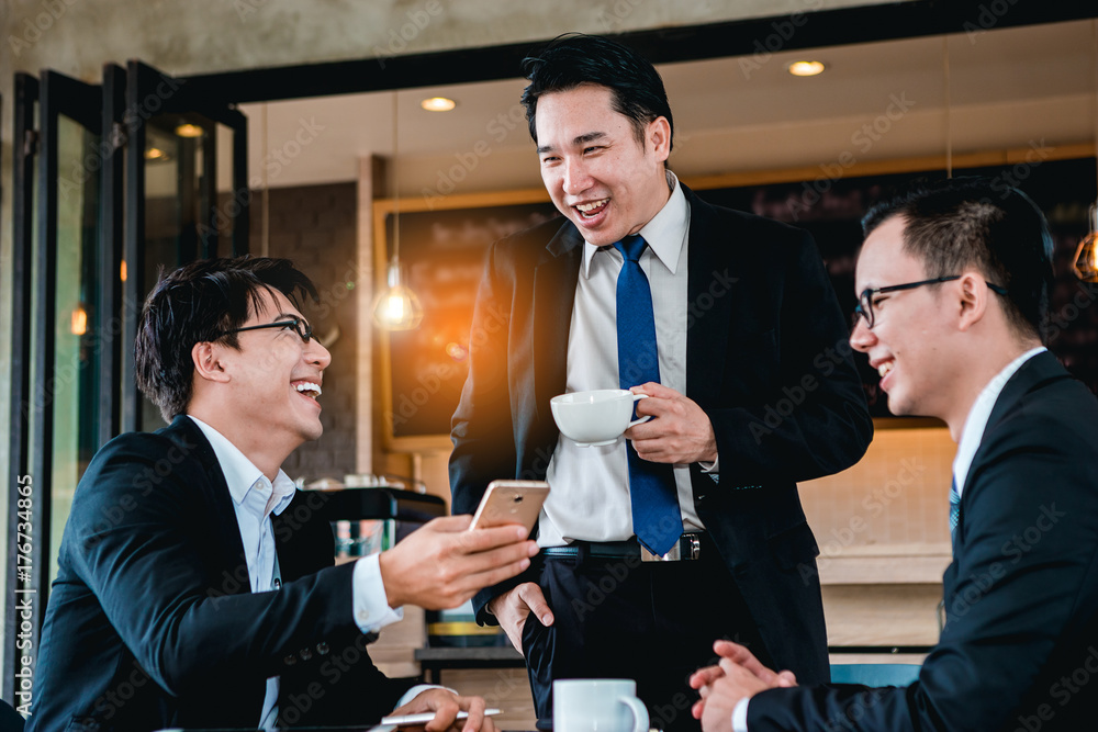 A group of men are businessmen sit together and succeeded in finding the various agreements.