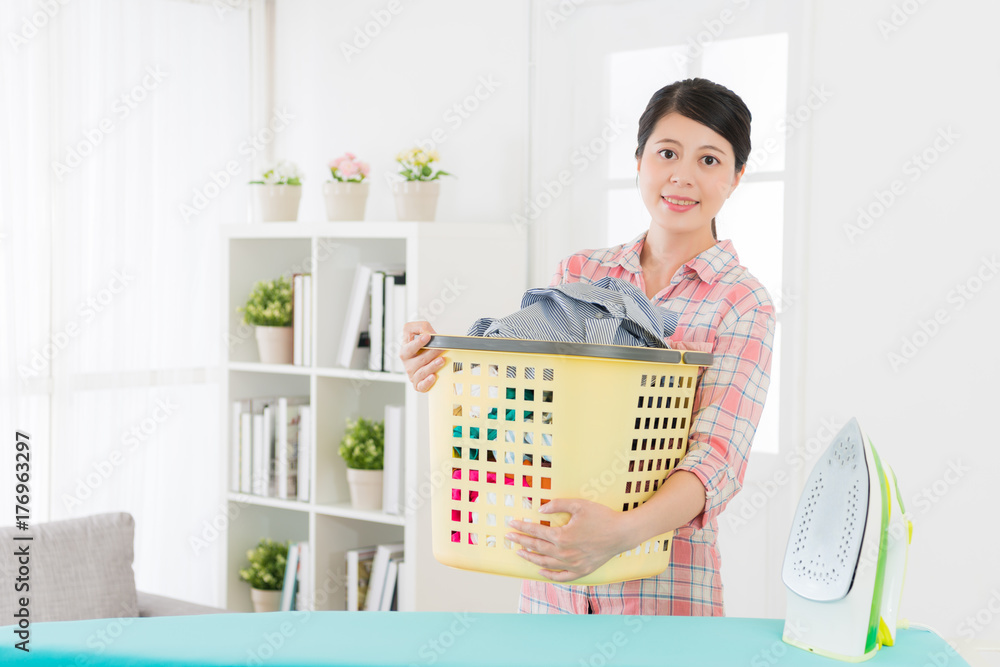 attractive housewife holding clean clothing