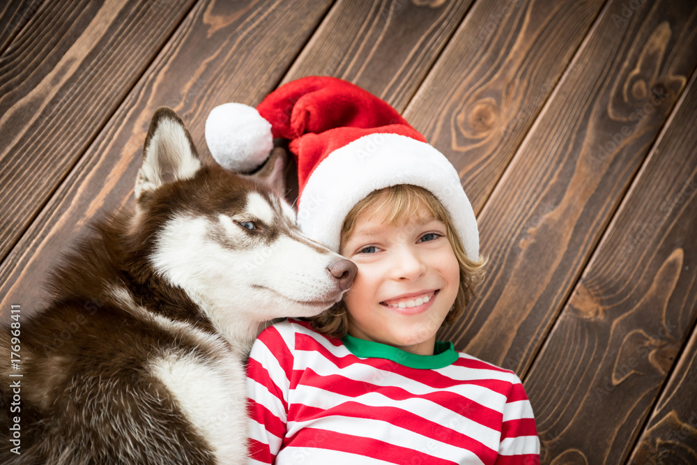 Happy child and dog on Christmas eve