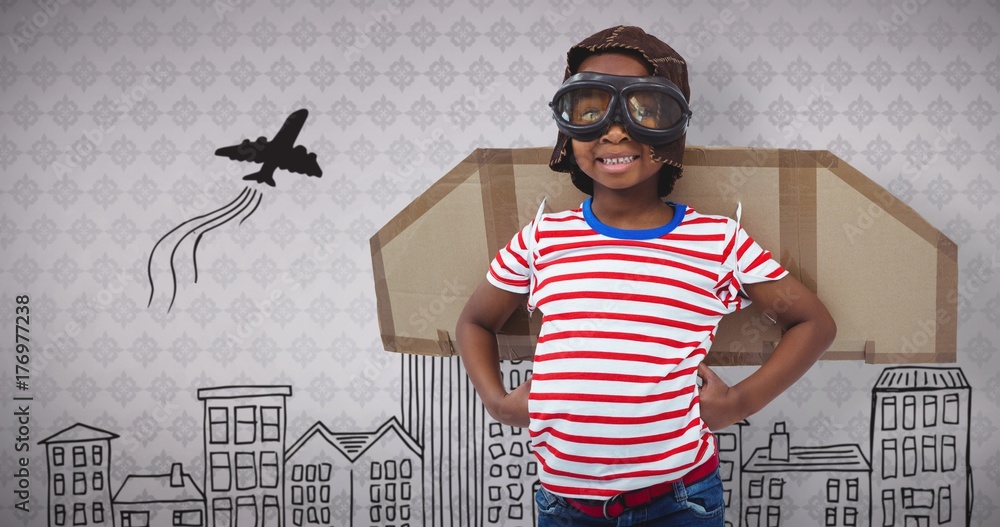 Composite image of smiling boy pretending to be pilot