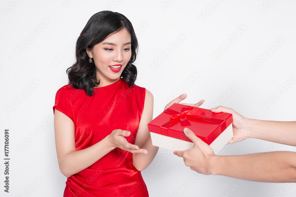 Beautiful happy asian woman in red dress receiving gift box