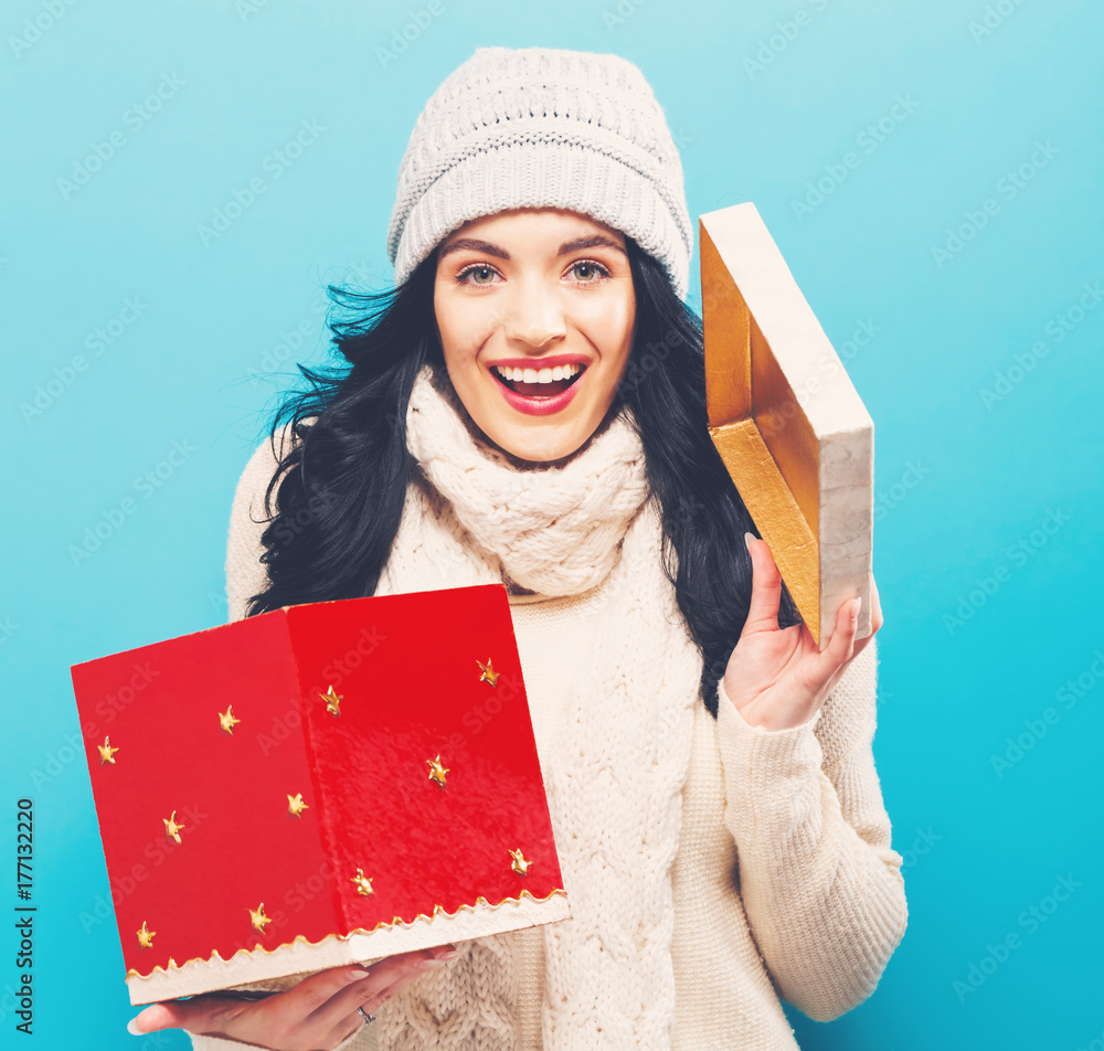 Happy young woman opening a Christmas present box