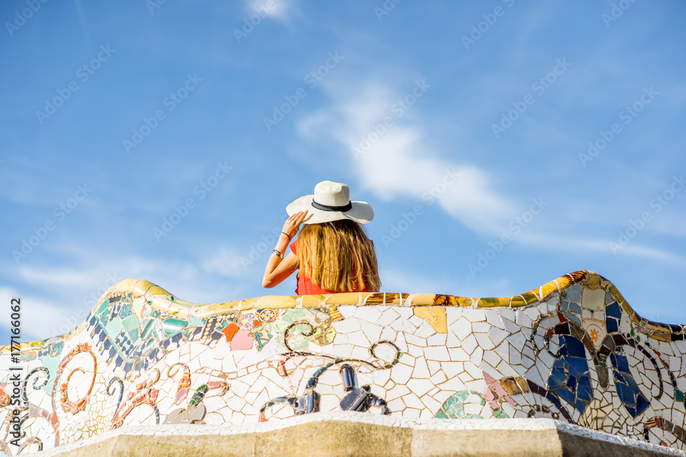 View on the beautiful terrace decorated with mosaic with happy woman tourist in Guell park in Barcel