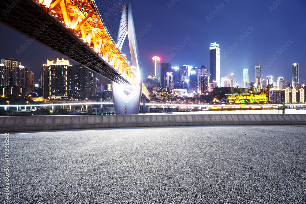 empty asphalt road with modern bridge and modern city