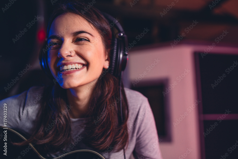 Woman singing a song in recording studio