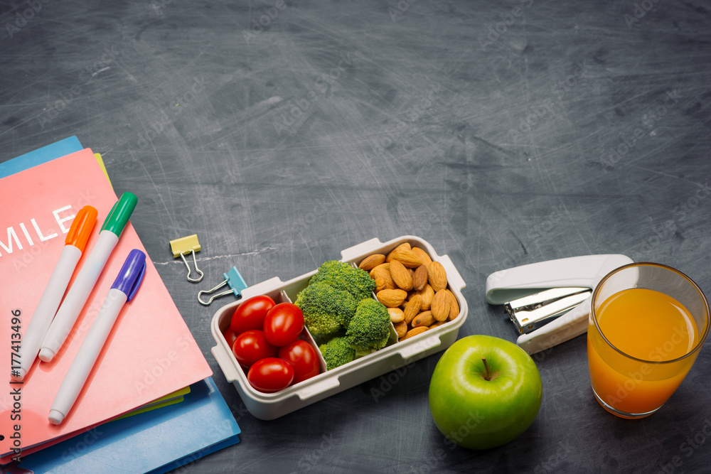 Lunch box with vegetables for a healthy school lunch on wooden table