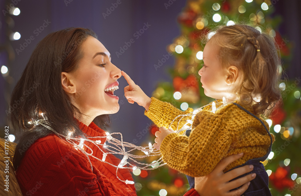 Mom and daughter near the Christmas tree