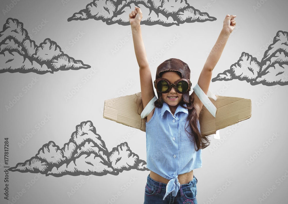 Girl against grey background with cardboard pilot wings and