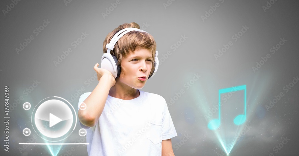 Boy against grey background with headphones and music player