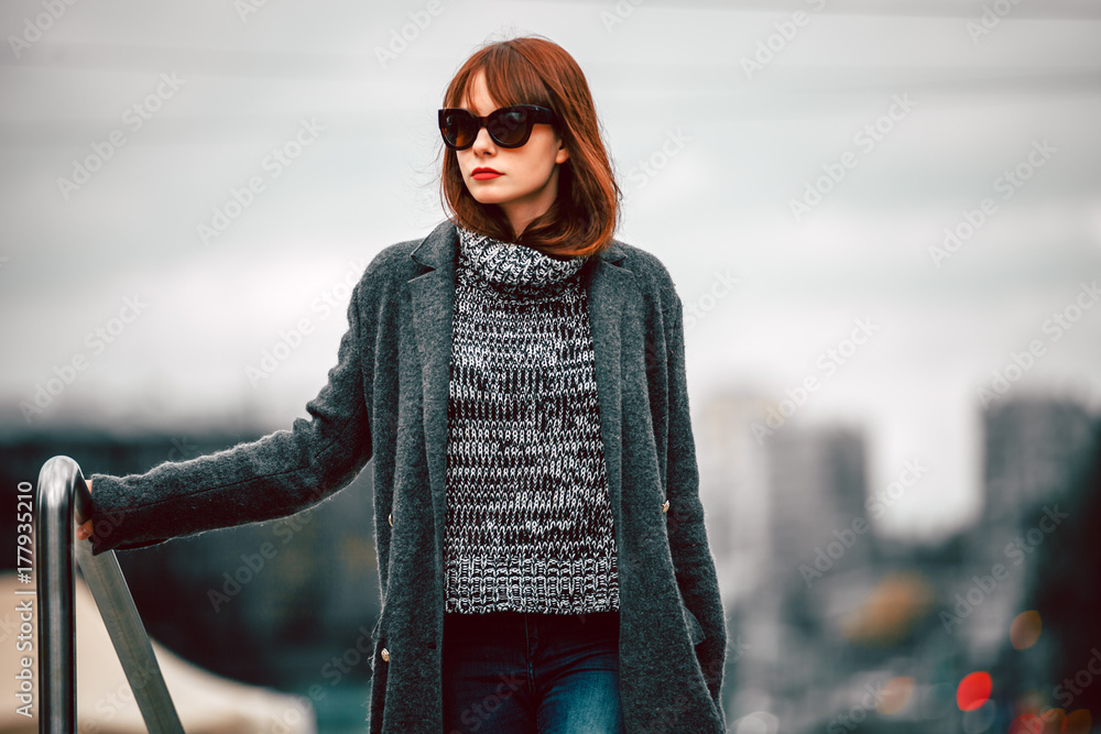 Pretty woman in coat on the autumn street