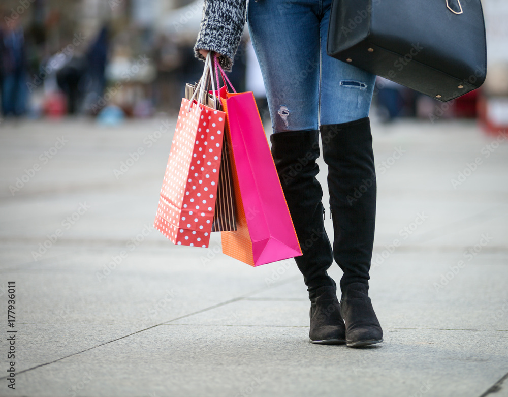 Closeup shopping bags holding by woman on the street