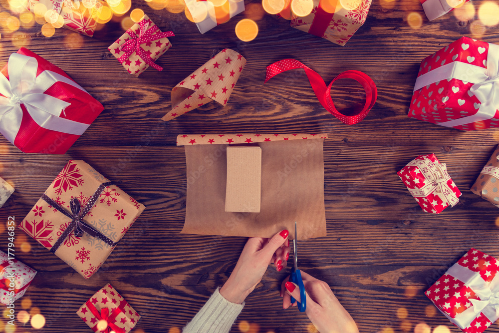 Detail of woman hands packing Christmas gifts