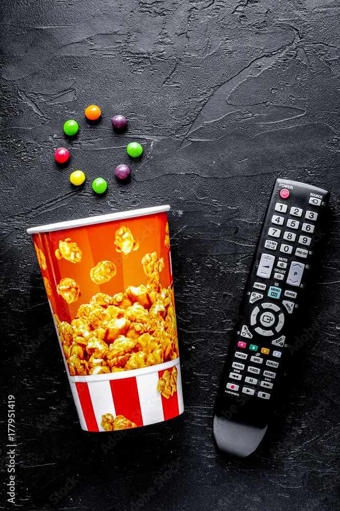 concept of watching movies with popcorn top view dark background