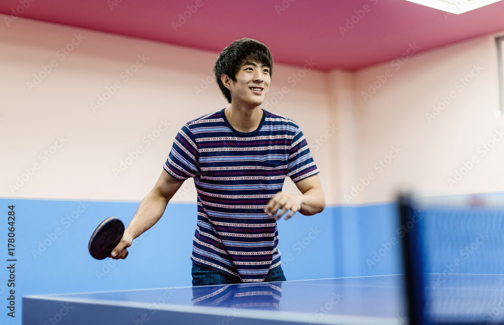 Asian guy playing table tennis