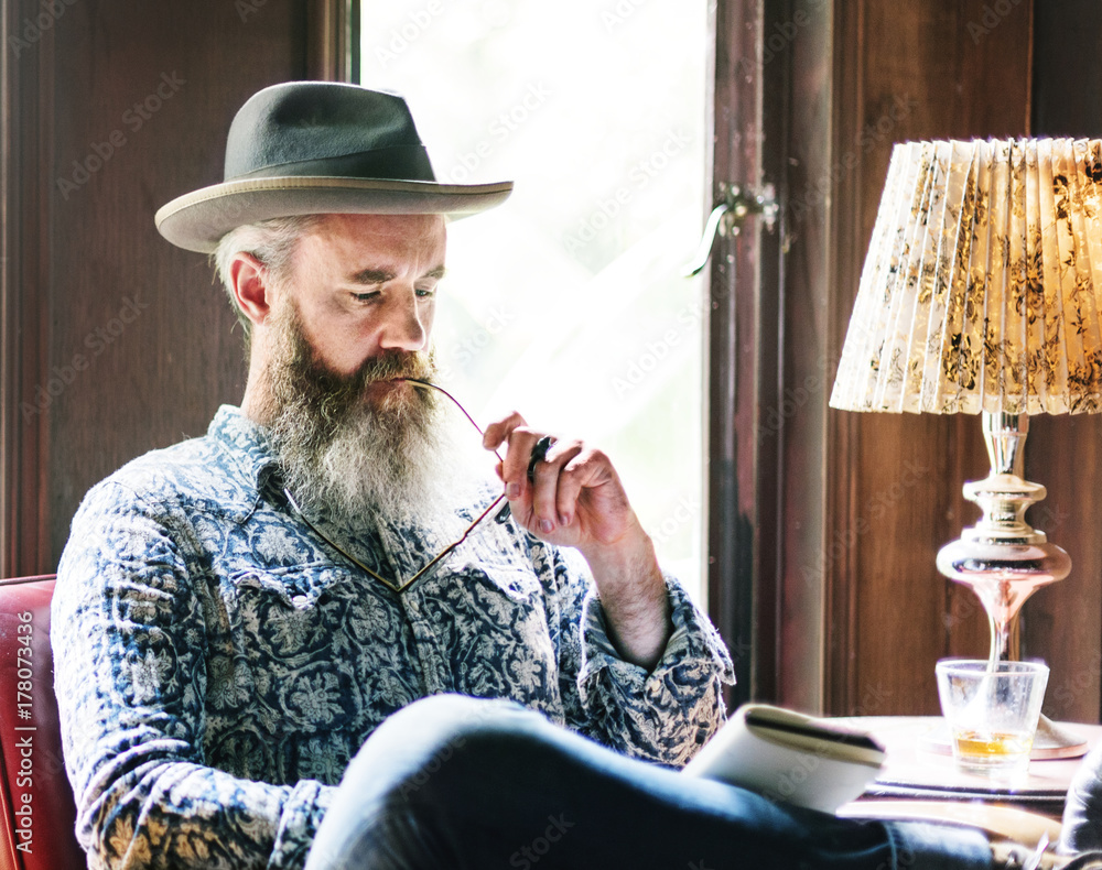 A man relaxing with a glass of whiskey