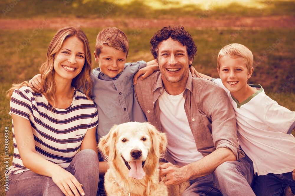 Portrait of family with dog in park