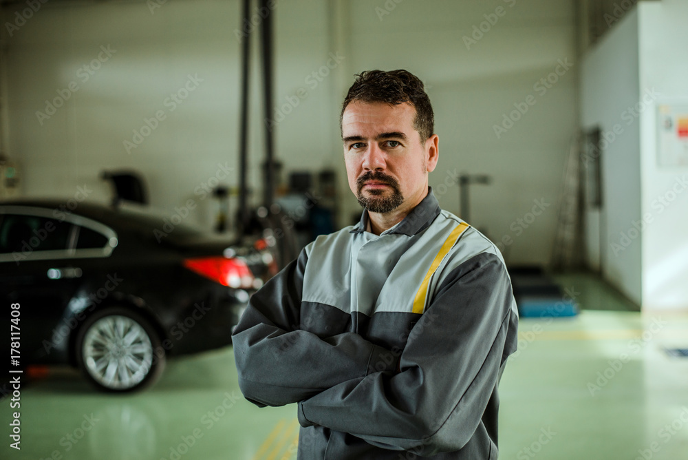 Portrait of a car mechanic in his shop.