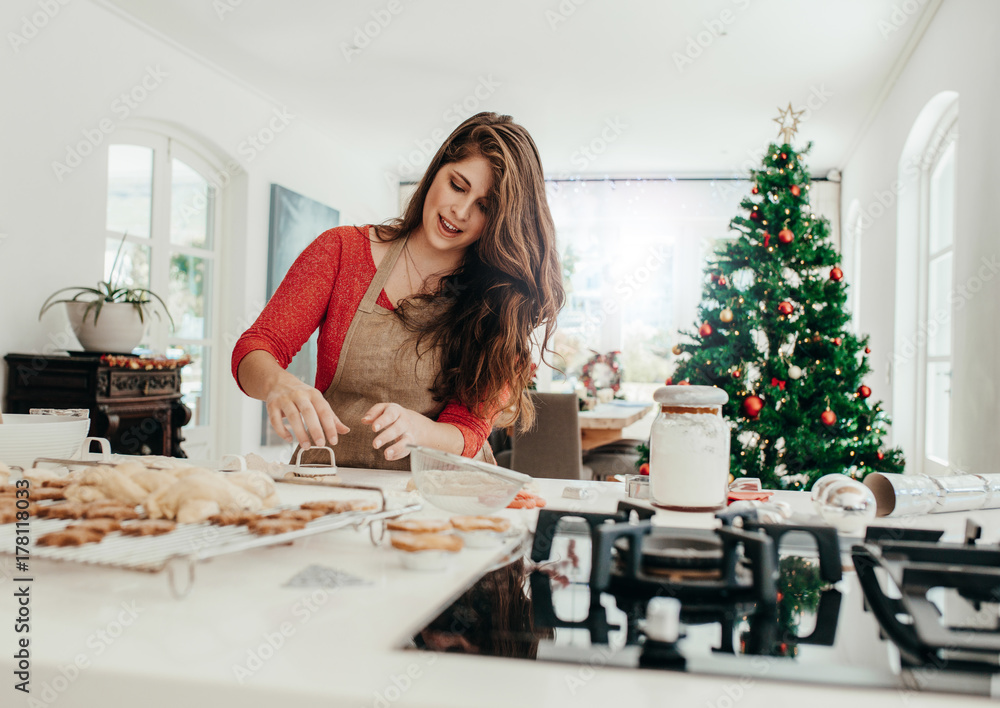 Woman preparing cookies for Christmas.