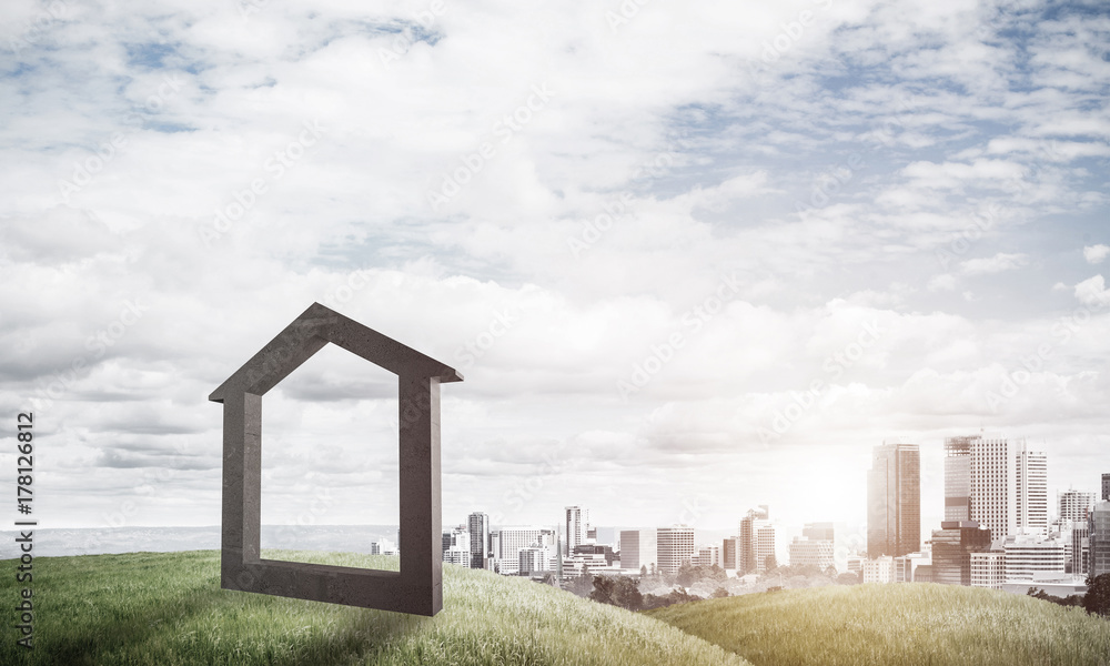 Conceptual image of concrete home sign on hill and natural lands