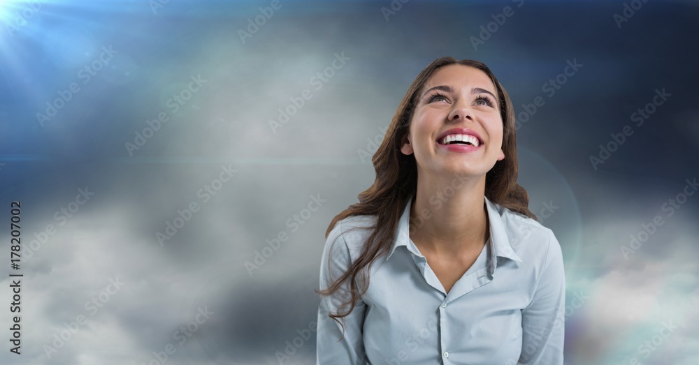 Woman looking up with cloudy background